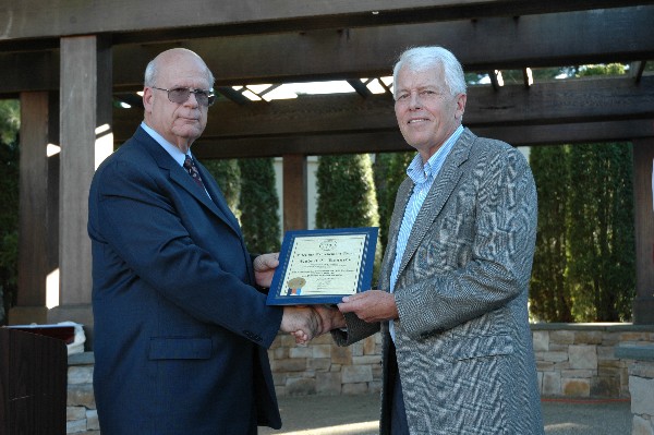 Kent Schneider (l), president and chief executive officer, AFCEA International, presents Kennedy with a Lifetime Achievement Award in August prior to his retirement as regional vice president.